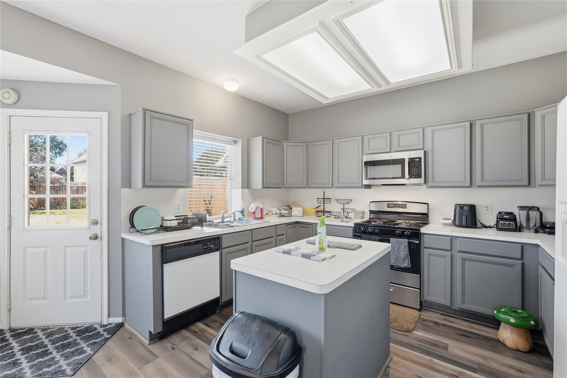 8706 Lone Maple Drive Houston, TX 77083 - Photo 15 of 27 a kitchen with a sink stove and cabinets