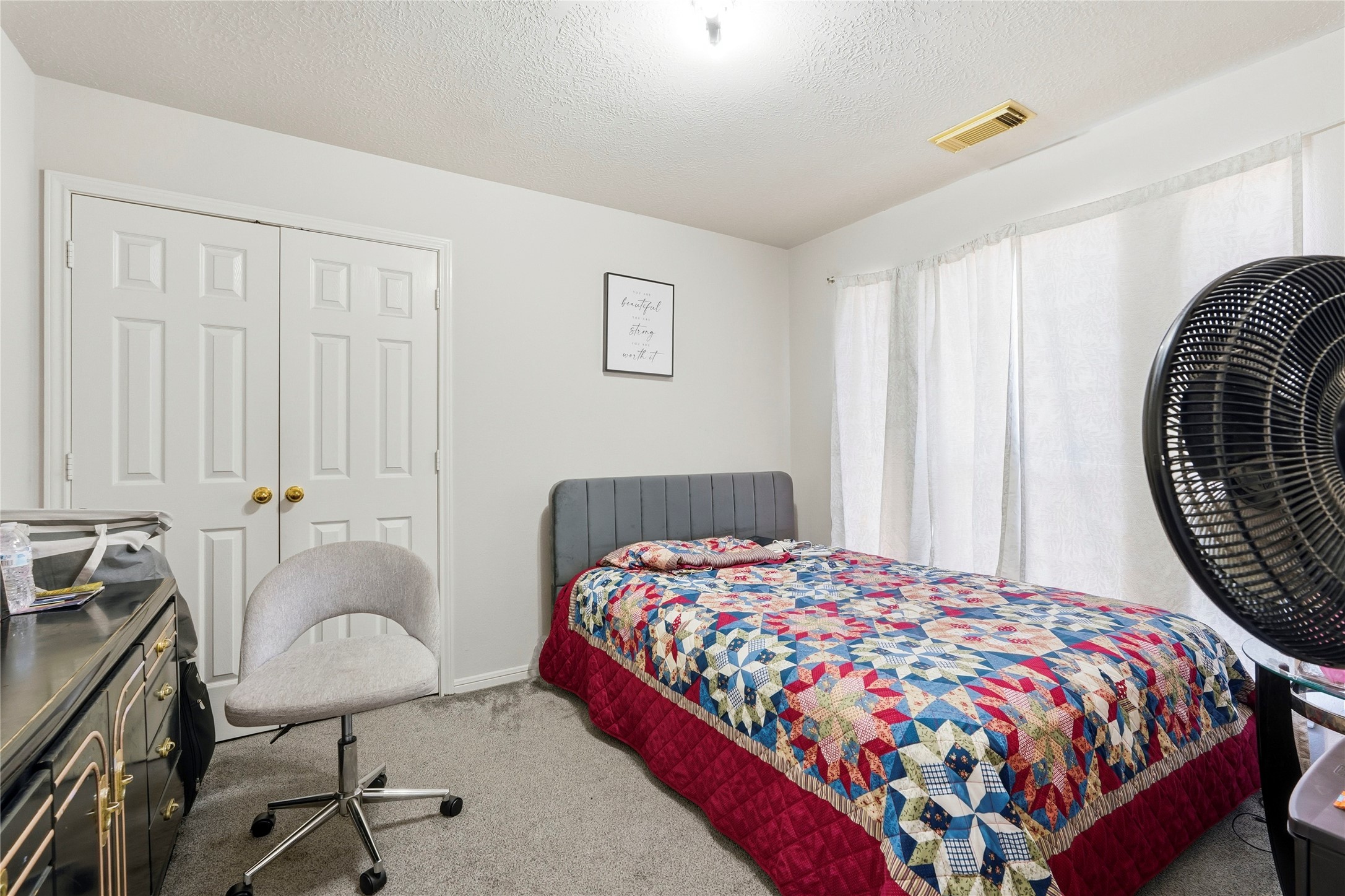 8706 Lone Maple Drive Houston, TX 77083 - Photo 17 of 27 a bedroom with a bed and a chair