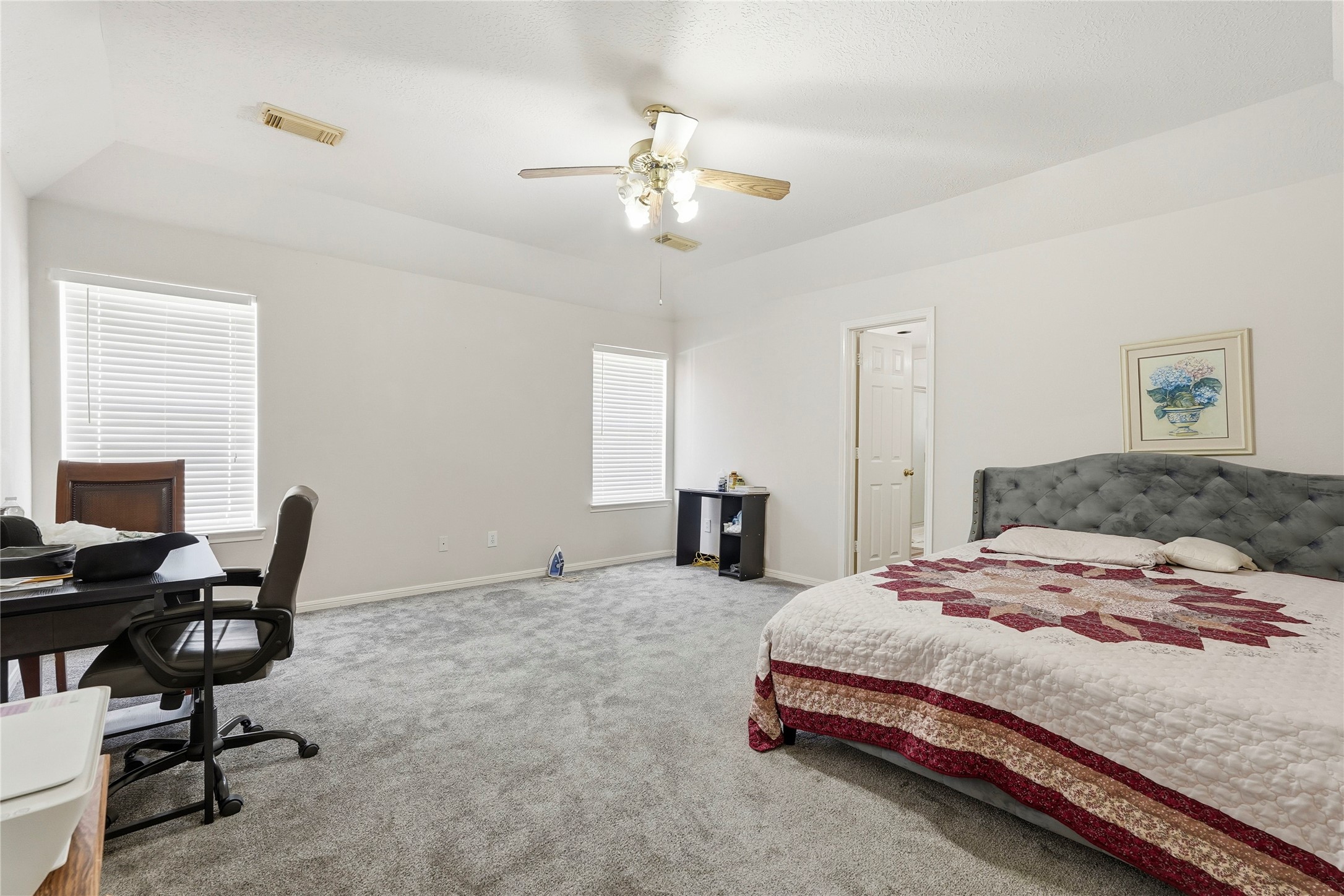 8706 Lone Maple Drive Houston, TX 77083 - Photo 22 of 27 a bedroom with a bed a desk and chair