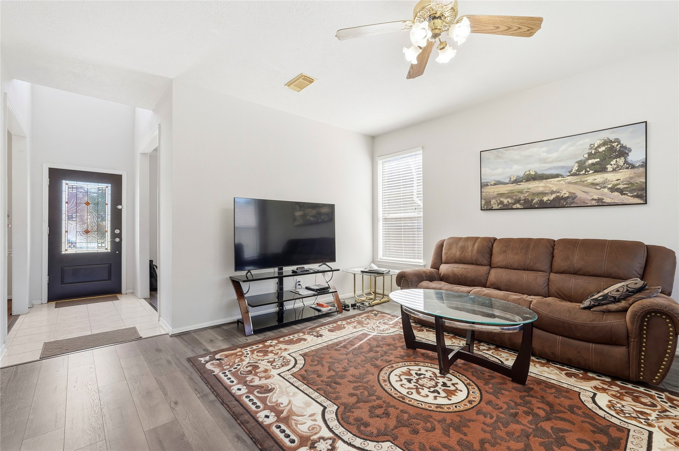 8706 Lone Maple Drive Houston, TX 77083 - Photo 9 of 27 a living room with furniture and a flat screen tv