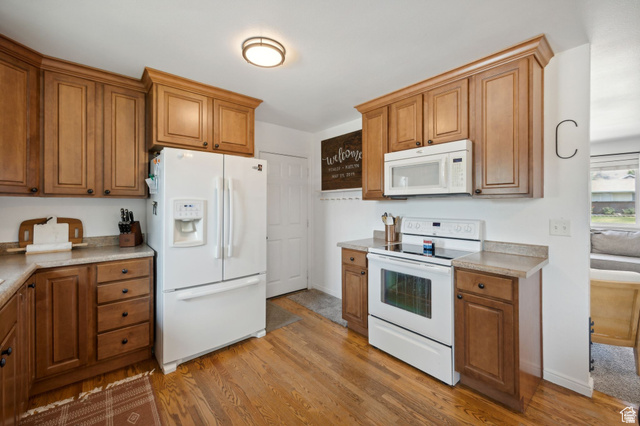 495 North 250 West Springville, UT 84663 - Photo 5 of 35 Kitchen with white appliances, light wood-style floors, wood finish cabinets, and light countertops