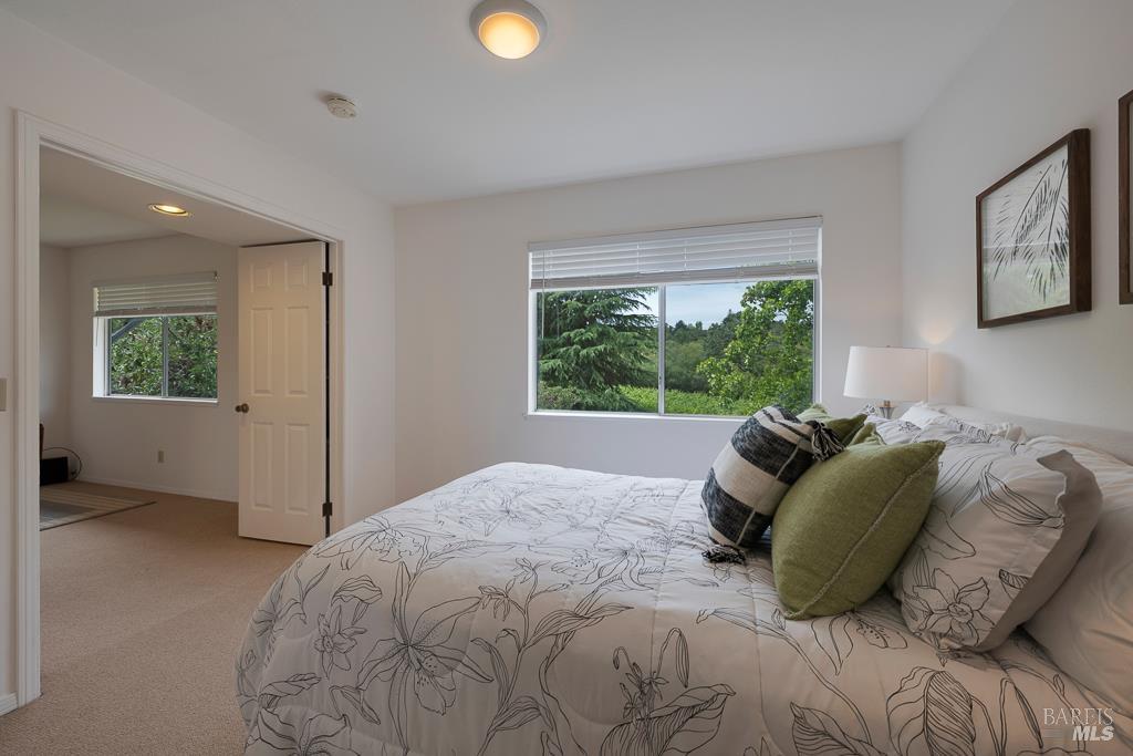 4542 Thomas Road Sebastopol, CA 95472 - Photo 25 of 60 a bed sitting in a bedroom next to a window