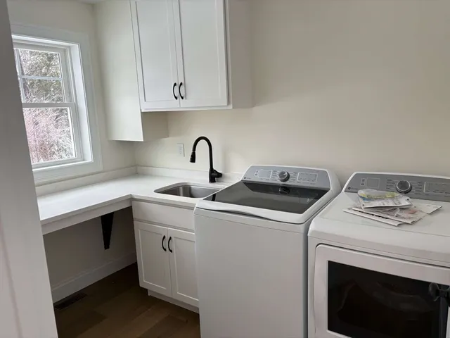 a view of washer and dryer with bathroom