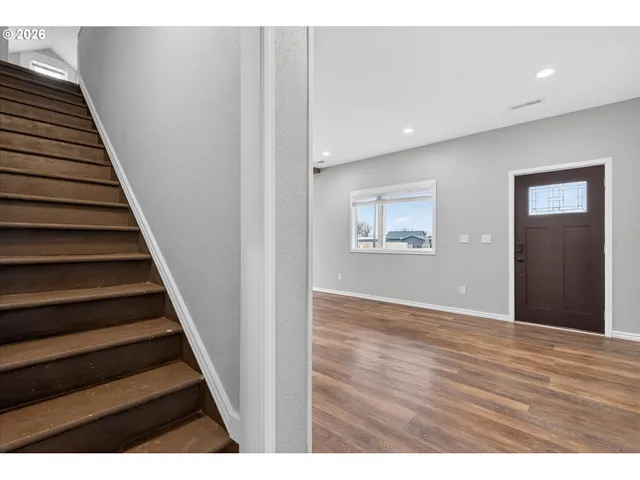 a view of an entryway with wooden floor