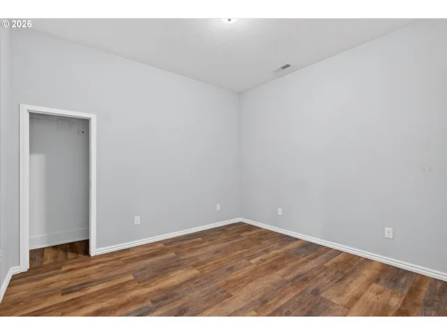 a kitchen with a wooden floor and a sink