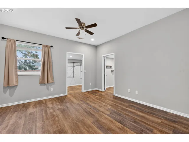 a view of wooden floor in a hall with a window