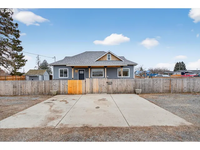 a front view of house with wooden fence