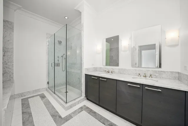 a bathroom with a shower sink and mirror