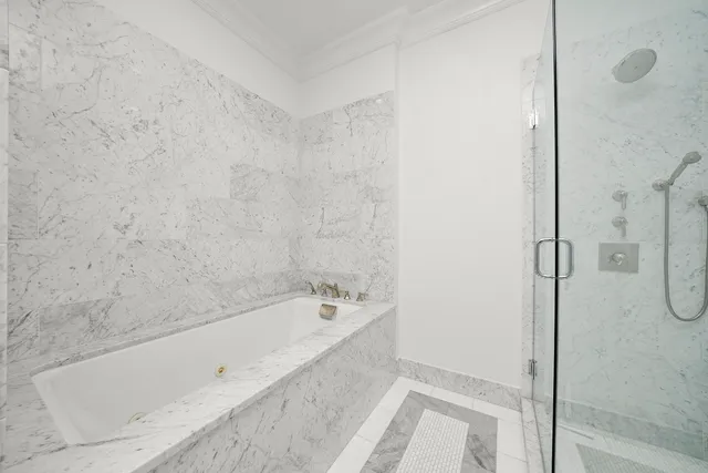 a bathroom with a bathtub and shower