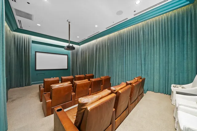 a room with furniture projector and screen