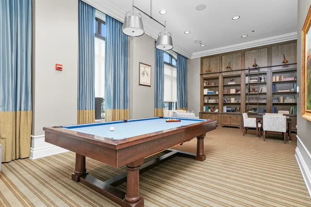 a living room with furniture a table and a large window