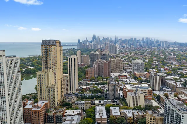 a building exterior with water fountain and trees