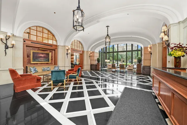 a view of a large room with lots of windows and furniture