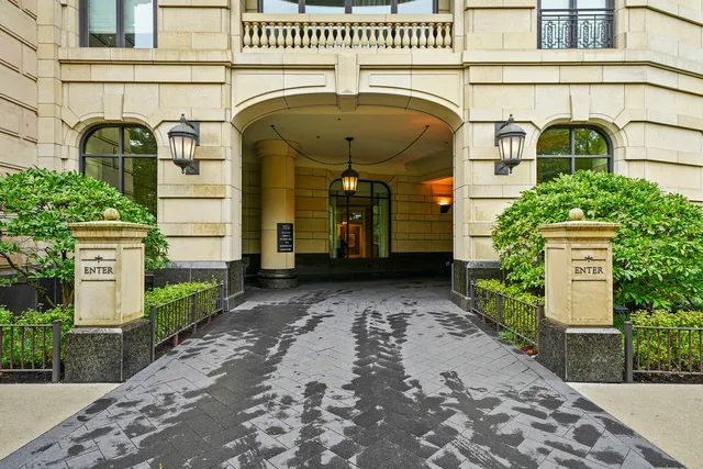 a view of a tall building next to a road
