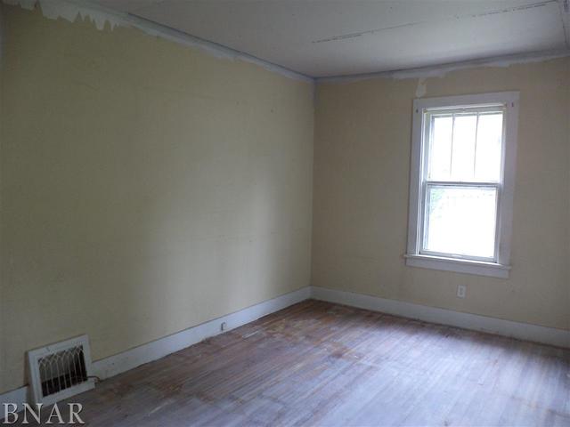 212 West Division Street Bloomington, IL 61701 - Photo 5 of 10 an empty room with wooden floor and windows