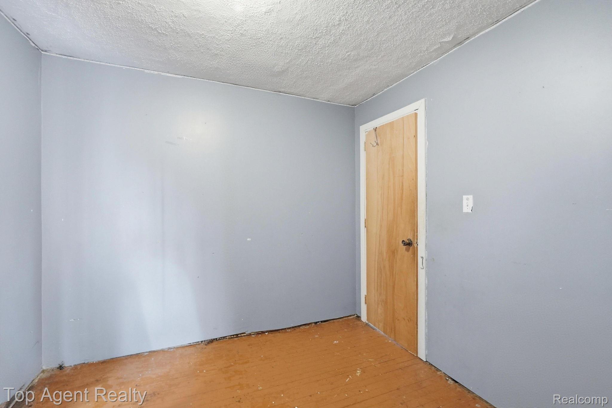 95 West Lapeer Road Peck, MI 48466 - Photo 16 of 33 Unfurnished room featuring hardwood / wood-style floors and a textured ceiling