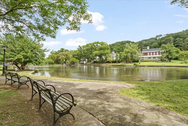 a view of a lake with table and chairs