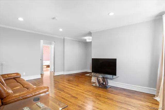 a living room with a flat screen tv and a floor to ceiling window