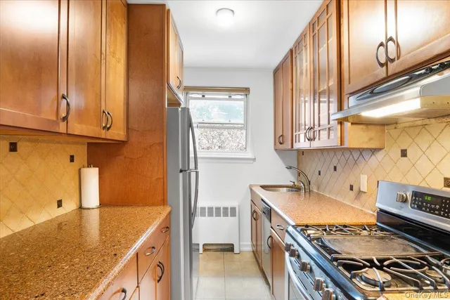 a kitchen with stainless steel appliances granite countertop a sink and a stove