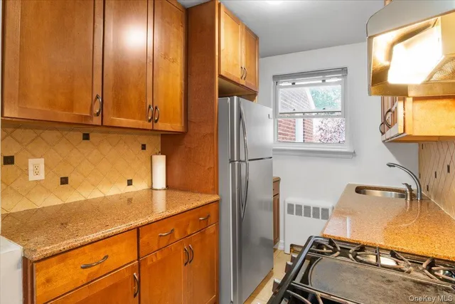 a view of a kitchen with wooden floor and windows