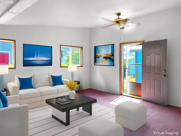 a view of a livingroom with a flat screen tv wooden floor and a window