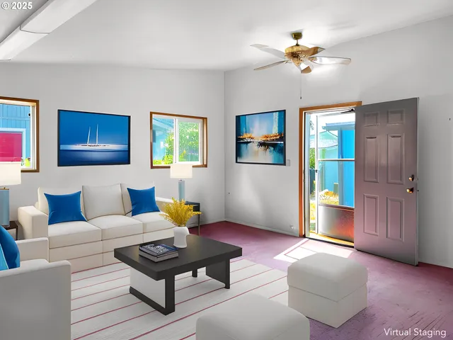 a view of a livingroom with a flat screen tv wooden floor and a window