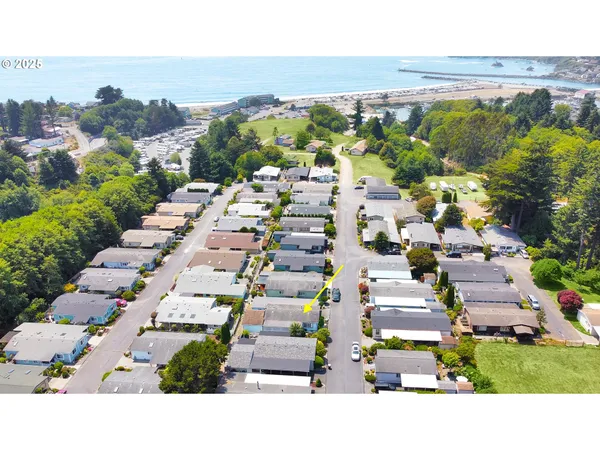 a open kitchen with granite countertop a stove a sink dishwasher and wooden cabinets