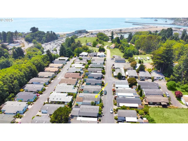 a open kitchen with granite countertop a stove a sink dishwasher and wooden cabinets