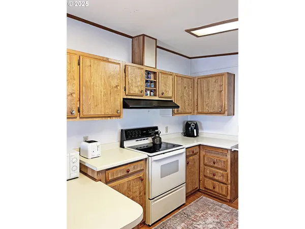 a kitchen that has a sink and a stove top oven