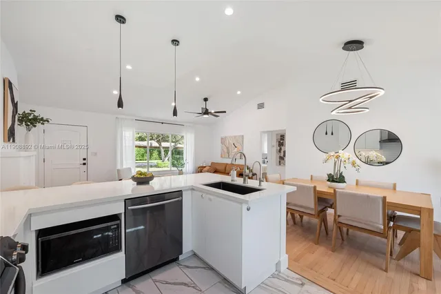 a view of a dinning table and chairs in patio of the house