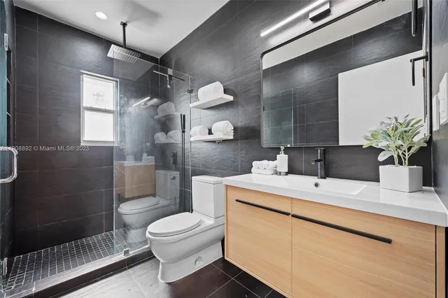 a bathroom with a toilet and a shower