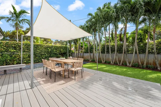 a view of a table and chairs in patio with wooden fence