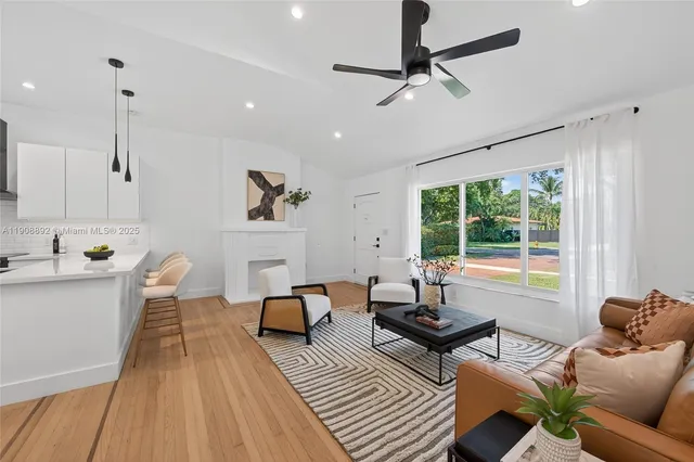 a living room with furniture and a large window