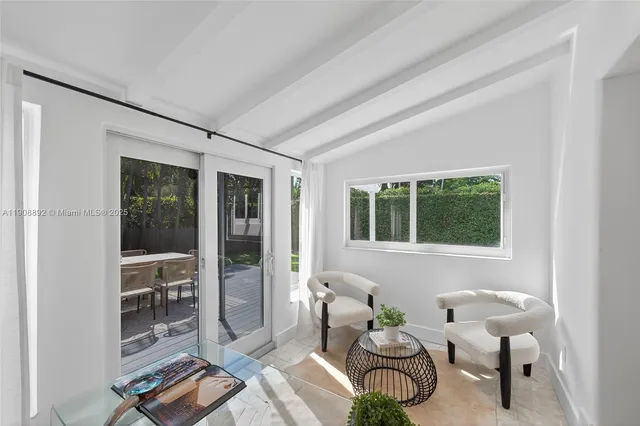 a view of a bedroom with furniture and a window