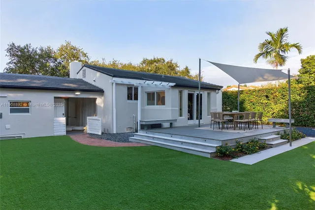 a front view of house with yard and outdoor seating