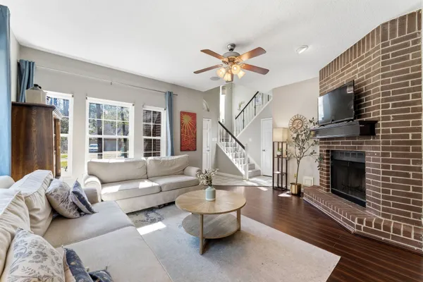 a living room with furniture a fireplace and a flat screen tv