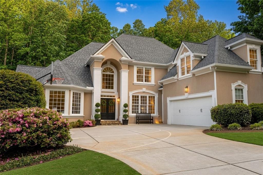 14375 Morning Mountain Way Milton, GA 30004 - Photo 1 of 53 a front view of a house with a garden