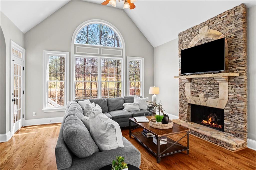 14375 Morning Mountain Way Milton, GA 30004 - Photo 11 of 53 a living room with furniture a flat screen tv and a fireplace