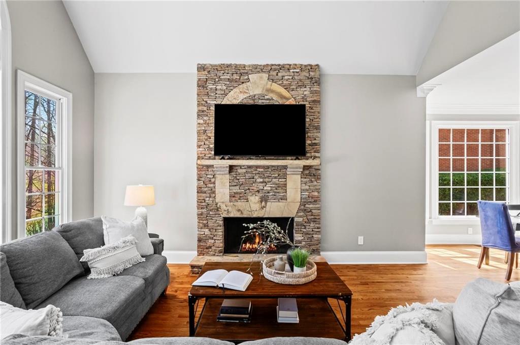 14375 Morning Mountain Way Milton, GA 30004 - Photo 12 of 53 a living room with furniture a fireplace and a flat screen tv