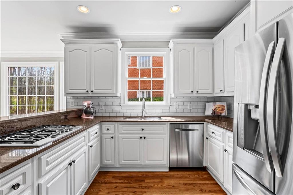 14375 Morning Mountain Way Milton, GA 30004 - Photo 16 of 53 a kitchen with granite countertop a sink stove and refrigerator