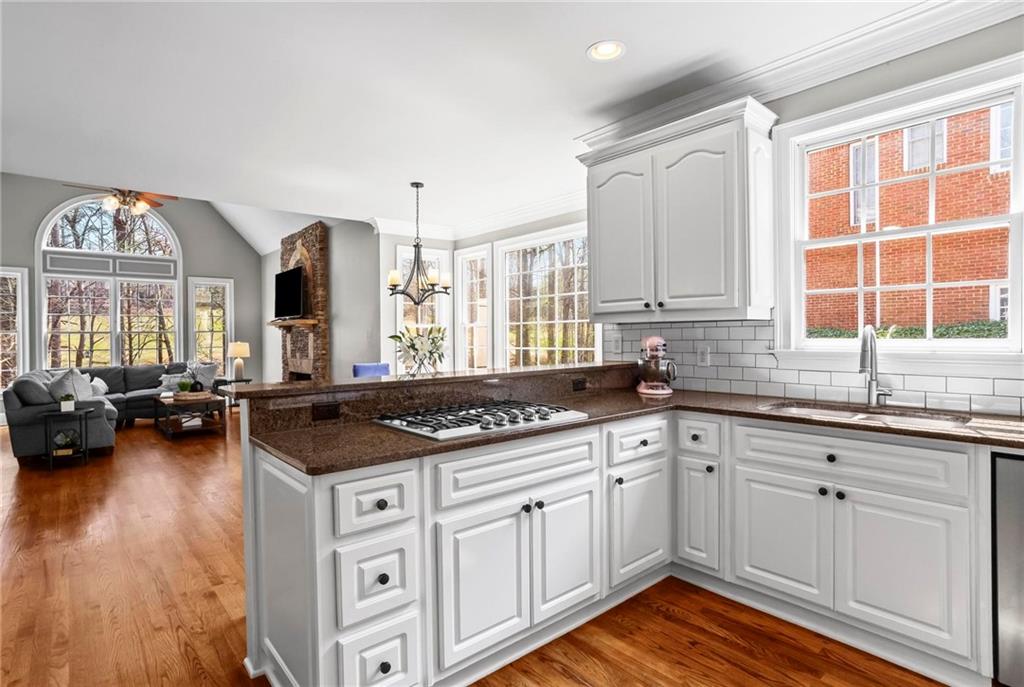 14375 Morning Mountain Way Milton, GA 30004 - Photo 17 of 53 a kitchen with a stove a sink a refrigerator and wooden floor