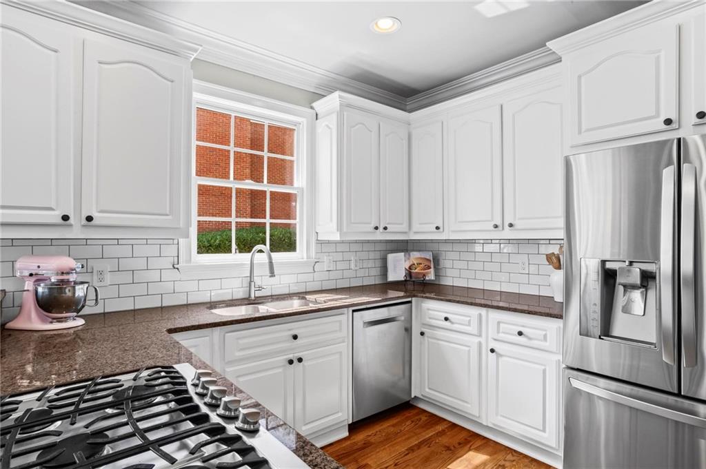 14375 Morning Mountain Way Milton, GA 30004 - Photo 19 of 53 a kitchen with granite countertop a sink stainless steel appliances and cabinets