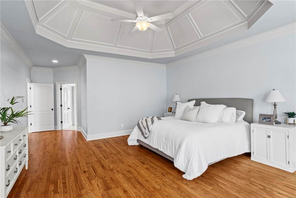14375 Morning Mountain Way Milton, GA 30004 - Photo 25 of 53 a spacious bedroom with a bed and a chandelier