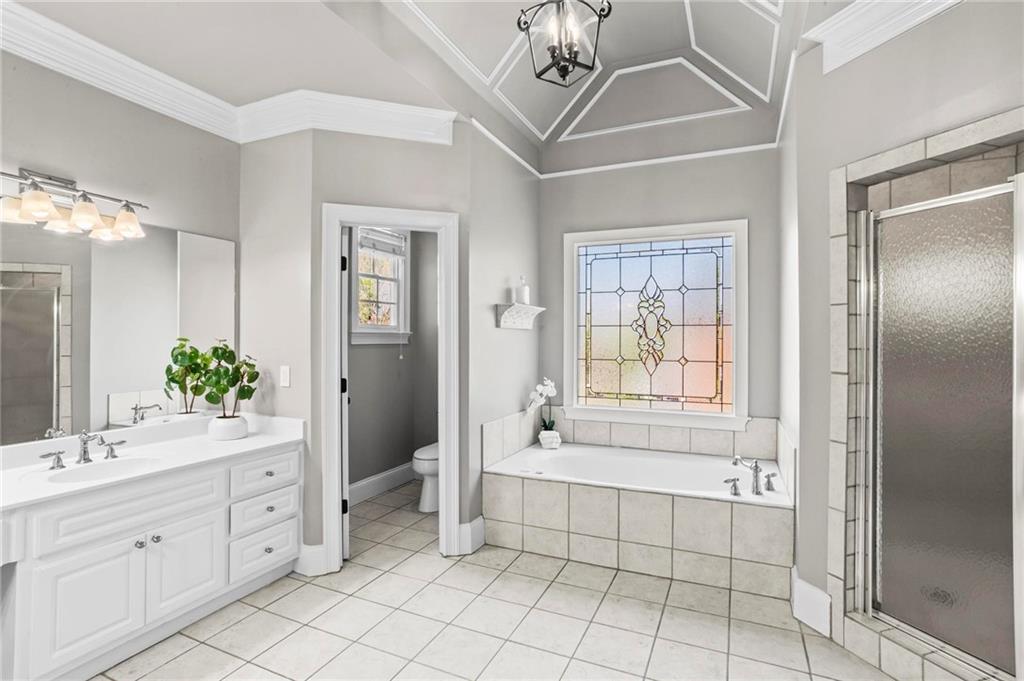 14375 Morning Mountain Way Milton, GA 30004 - Photo 27 of 53 a spacious bathroom with a shower a mirror and a bathtub