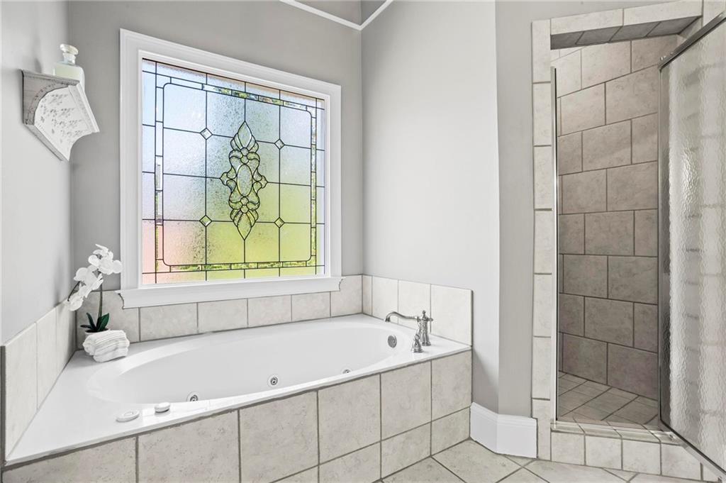 14375 Morning Mountain Way Milton, GA 30004 - Photo 28 of 53 a bathroom with a bathtub and shower