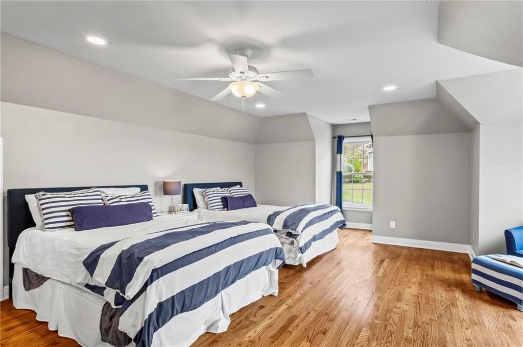14375 Morning Mountain Way Milton, GA 30004 - Photo 34 of 53 a bedroom with two beds and a chandelier
