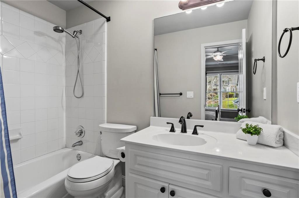 14375 Morning Mountain Way Milton, GA 30004 - Photo 36 of 53 a bathroom with a sink a toilet and shower