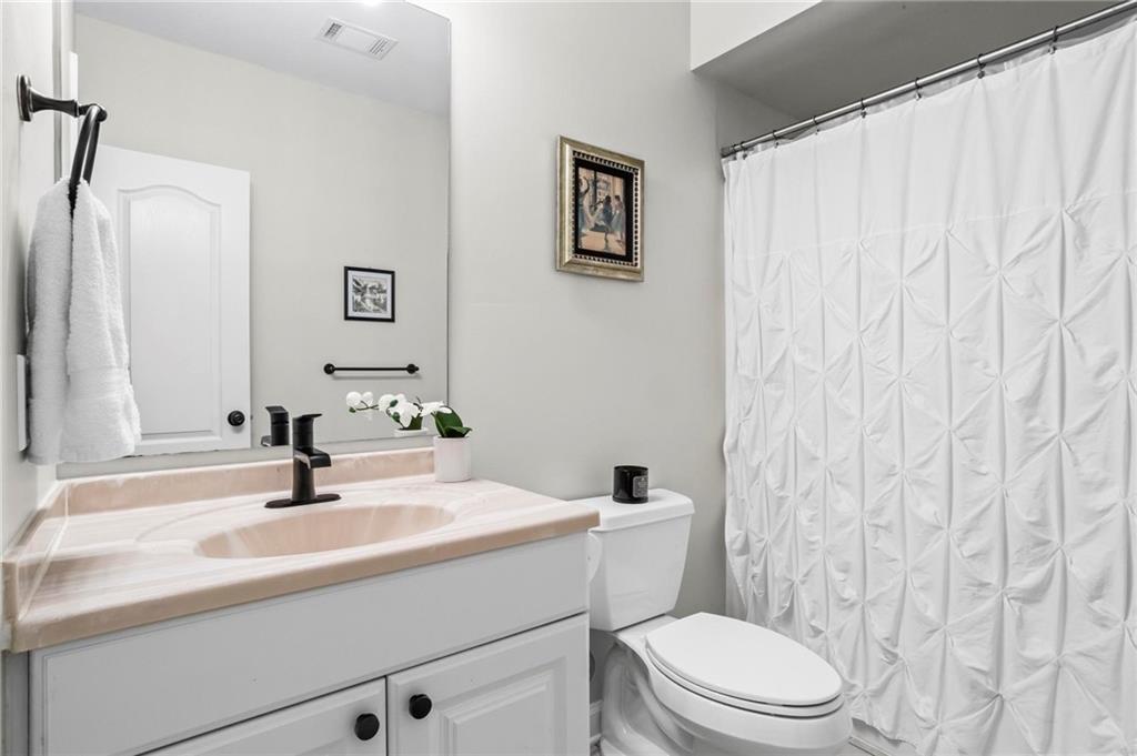 14375 Morning Mountain Way Milton, GA 30004 - Photo 41 of 53 a bathroom with a sink a toilet and shower curtain