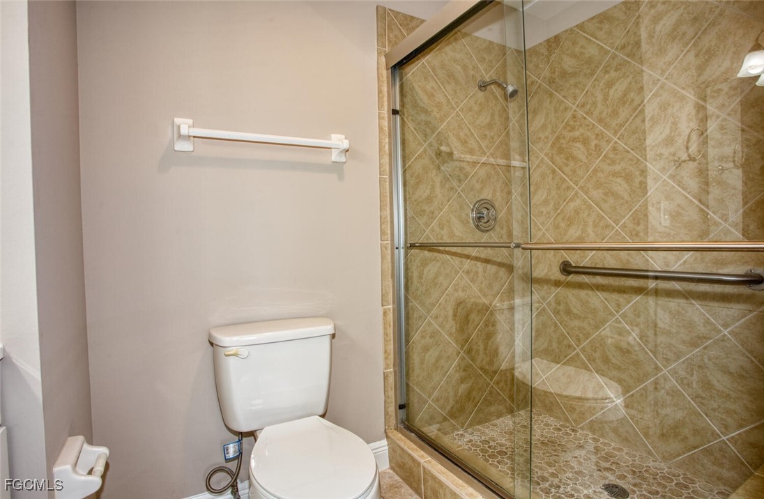 5917 Littlestone Court, Unit 118 North Fort Myers, FL 33903 - Photo 13 of 20 a bathroom with a toilet and a shower