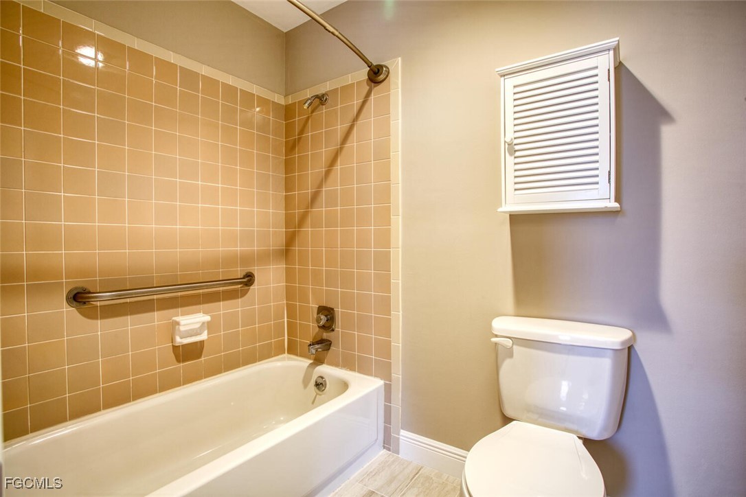 5917 Littlestone Court, Unit 118 North Fort Myers, FL 33903 - Photo 17 of 20 a bathroom with a toilet and a bathtub